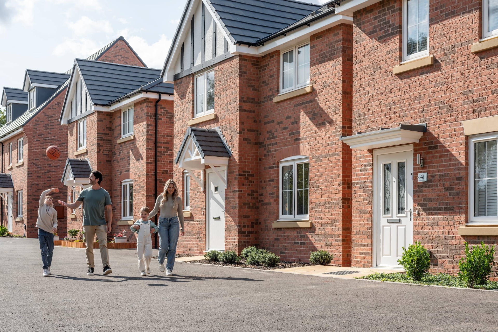 Family outside new build homes
